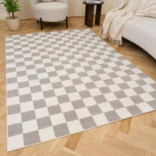 Checkered rug with gray and white squares on a wooden floor