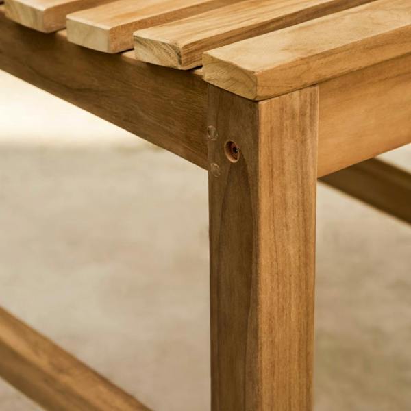 Side profile of the solid teak garden chair showing the leg support and seat thickness.