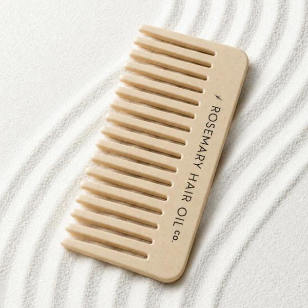 Beige comb with 'Rosemary Hair Oil Co.' branding on a beige background, wide tooth flat comb, 