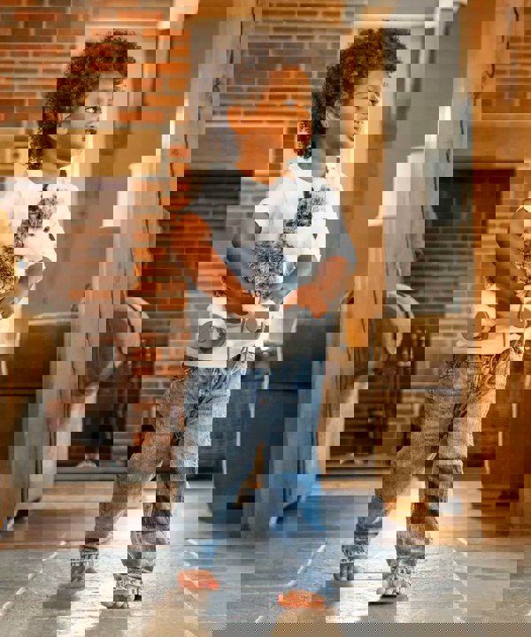 Boy carrying Husky teddy toy