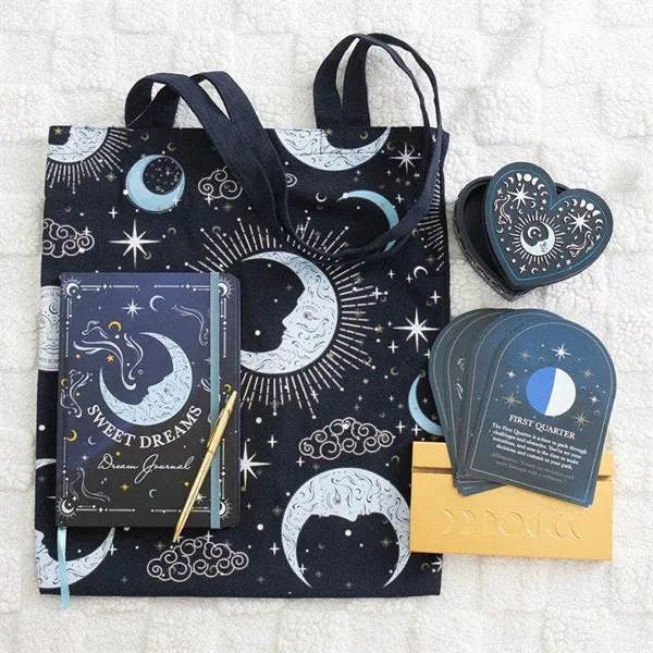 A5 dream journal with dark moon-and-stars cover, shown with matching tote and heart pouch