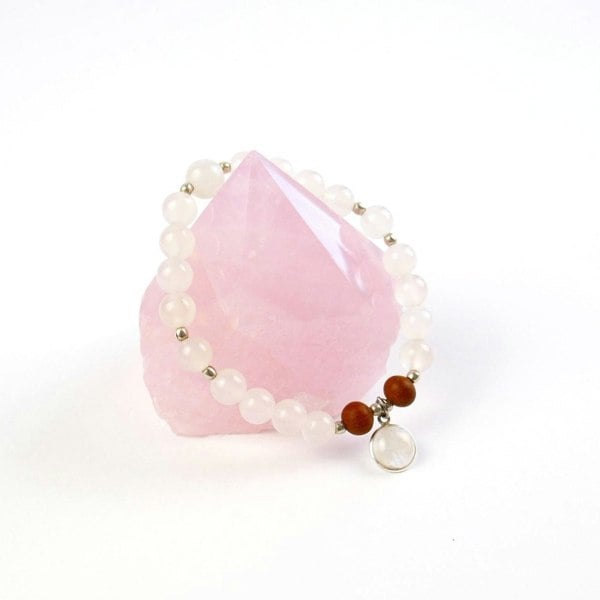 Selene purity mala bracelet by Kati Kaia with rose quartz and brown beads on a white background