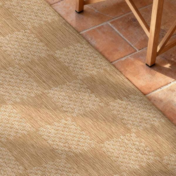 Beige carpet with a geometric pattern on a tiled floor.