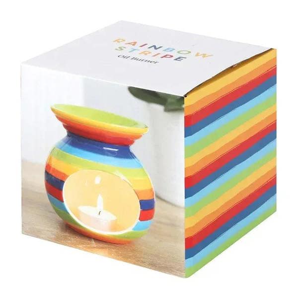 Rainbow striped oil burner shown in gift box, glossy ceramic with small lit tealight