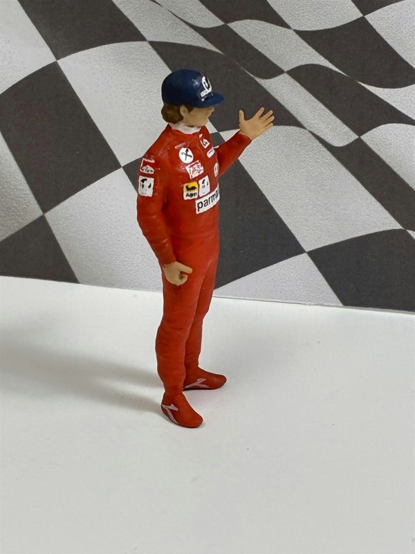 a toy figure of a man in a red uniform