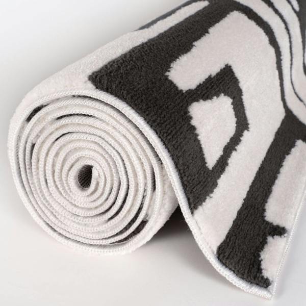 Roll of black and white patterned tape on a light gray background
