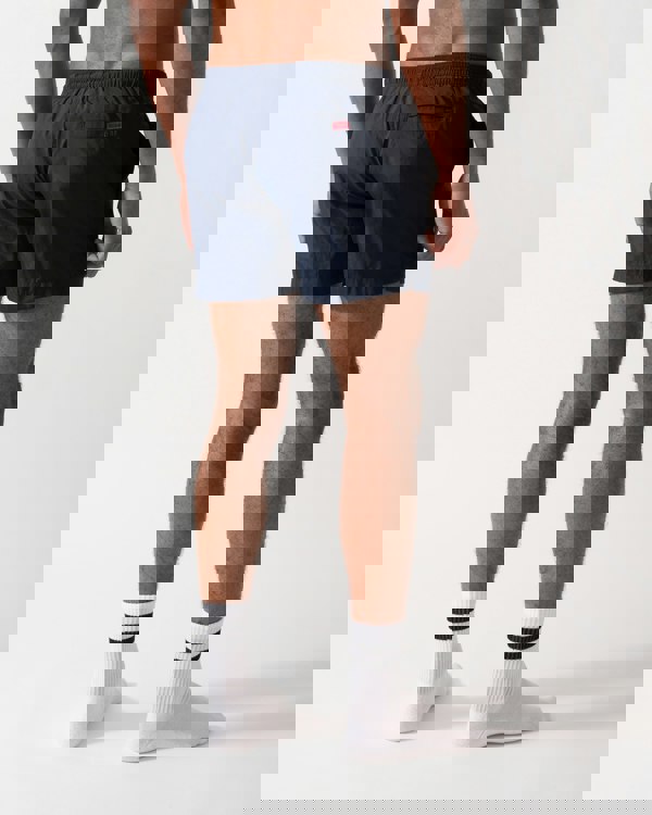 Back shot of a Model wearing a HUGO Dominica Mens Quick-Drying Swim Shorts In Recycled Material With Logo in Dark Blue