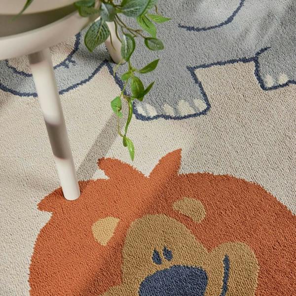Children's rug with a lion design on a light-colored floor.