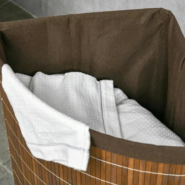 Brown bamboo hamper interior with removable white liner bag and folded towels