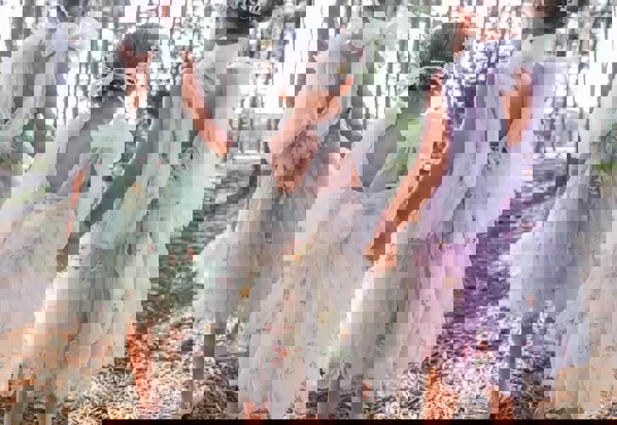 3 young girls wearing pretty dresses