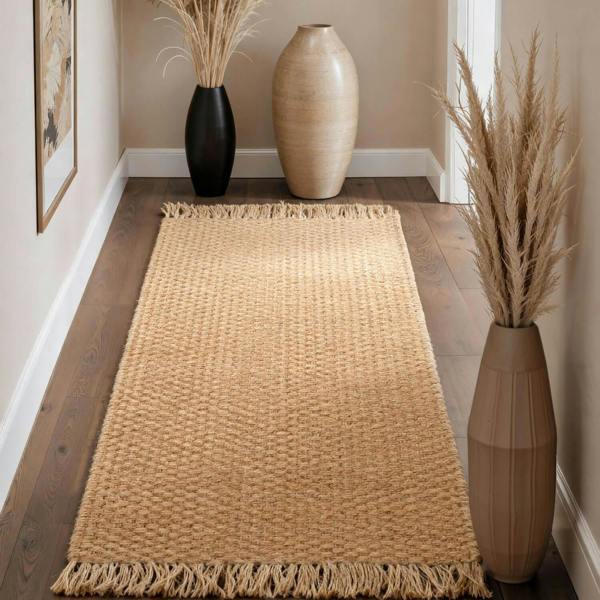 Woven jute rug with decorative vases and plants in a room setting.