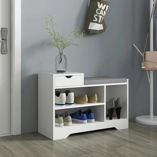 Front view of a white shoe bench with gray seat and open cubby compartments for shoes