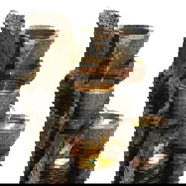 Rustic electric water feature with cascading bowls, textured stone finish, and warm LED lights, enhancing outdoor decor