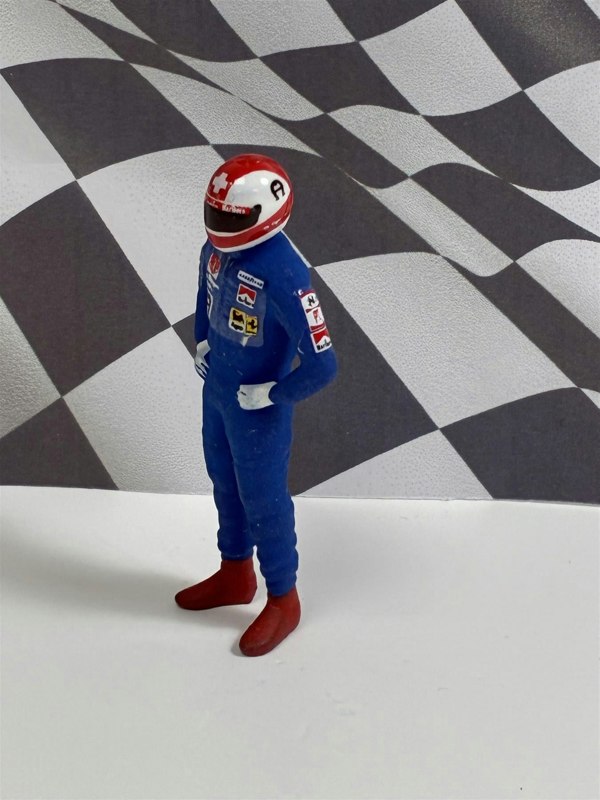 a toy figure in a race car suit
