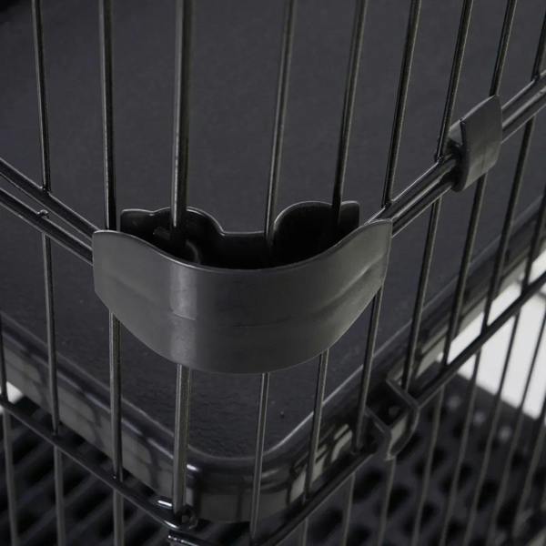 Black plastic hanging bowl holder inside a small animal cage with metal wire bars