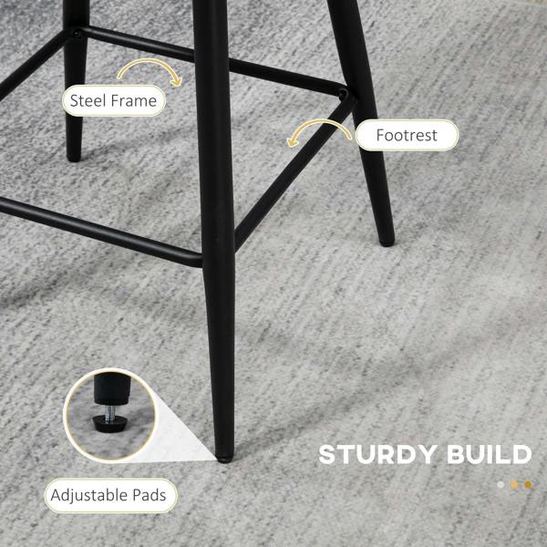 Black steel footrest and frame detail on cream boucle bar stool