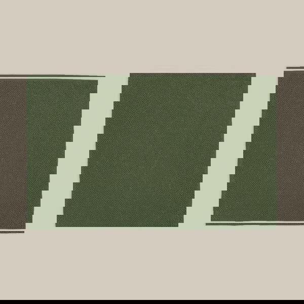 Dark green bath mat made from organic cotton. Soft and sustainable bathroom accessories.