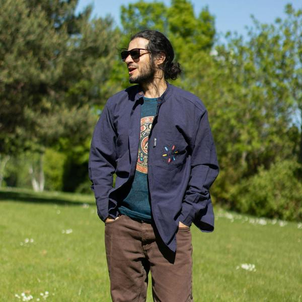 Blue graphic t-shirt under a dark overshirt, crew neck and short sleeves