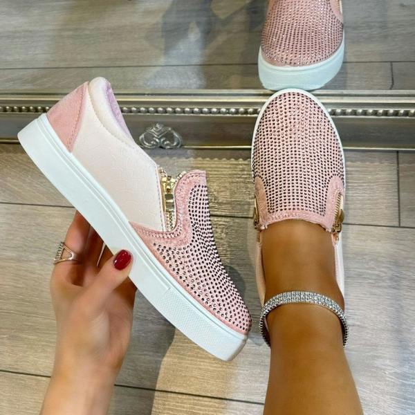 Pink sneakers with white soles on a wooden floor