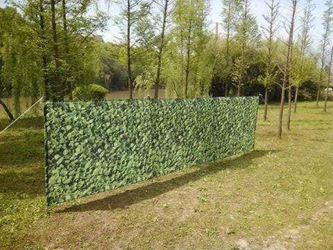 Laurel Hedge 4 Pole Compact Windbreak with Steel Poles by OLPRO pictured in a field.