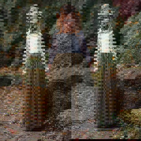 pretty flower girl holding her skirt