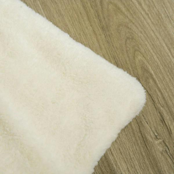 Beige plush cushion for a dog crate end table, soft fabric cover.