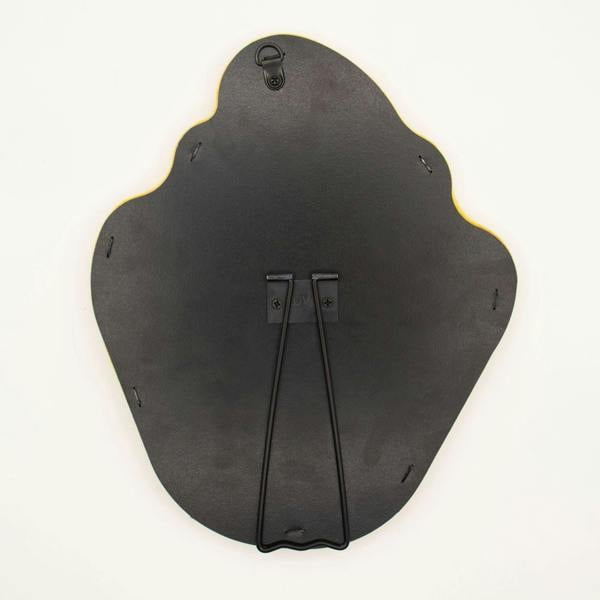 Back of squiggly flame mirror with dark backing and hanging hardware