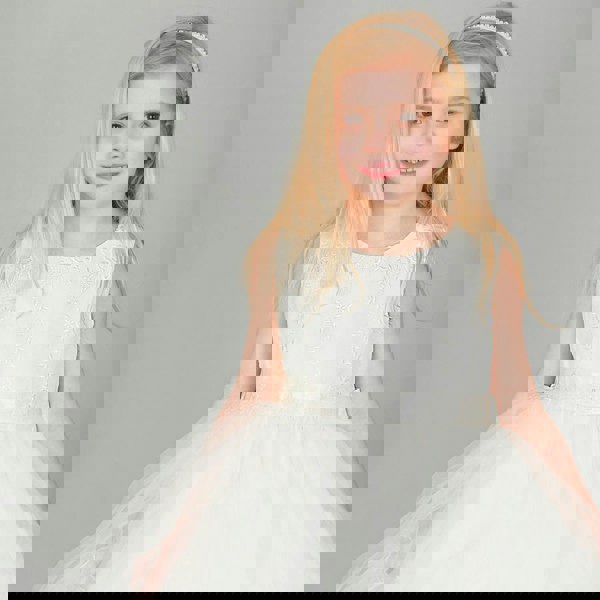 Girl wearing UK Flower Girl Boutique ivory coloured dress