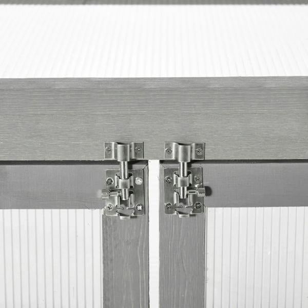 Hinged door latch hardware on dark grey greenhouse frame with transparent panel