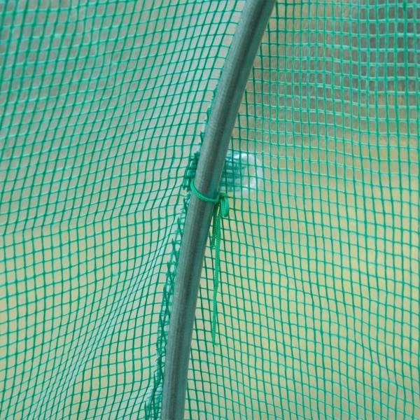 Close-up of green greenhouse cover fabric grid with secured edge seam detail