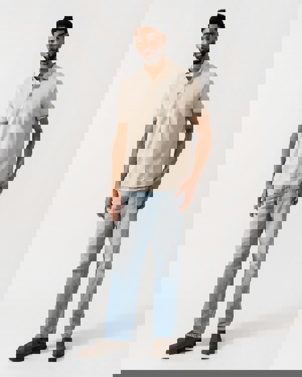 Model wearing BOSS Green Mens Paddy Cotton-Piqué Polo Shirt with Contrast Logo in Light Beige 275 - Full Length