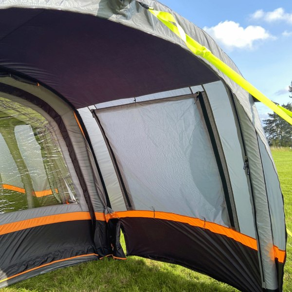 An image of the OLPRO Charcoal & Orange Cocoon Breeze Campervan Awning Extension attached to the Cocoon Breeze that has been fixed to a VW Campervan.