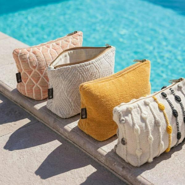 Small indigo jacquard zip toiletry pouch among other bags by pool