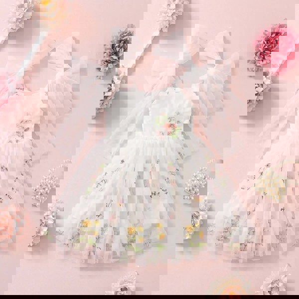 white dress with pretty bow shoulder ties and embroidery