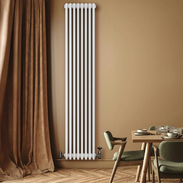 Traditional 4 column radiator in white, 1800 x 380mm, mounted on a wall with a warm-toned backdrop and stylish dining setup nearby