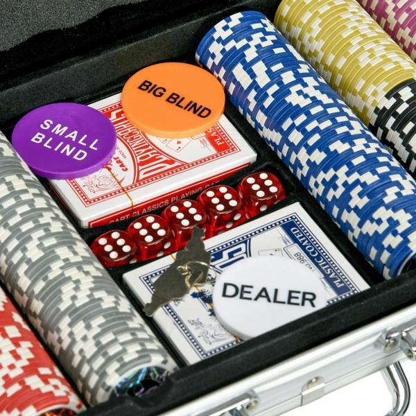 Close-up of poker chips, playing cards, dice, and dealer slot inside aluminum case