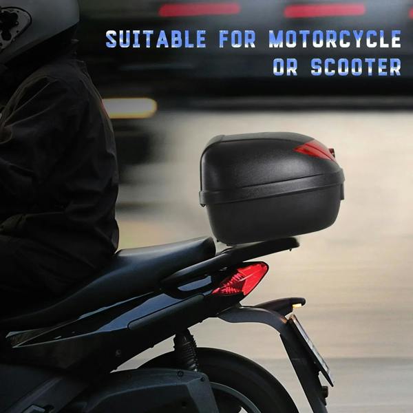 Black motorcycle top case on scooter, side view with red tail light