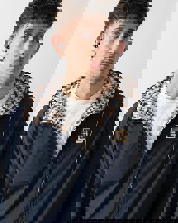 close up studio shot of a model wearing an Aquascutum Mens RLG Badge Reversible Sailor Jacket in Navy 11