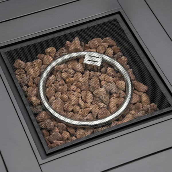 Close-up of gas fire pit burner with lava rocks under mesh screen