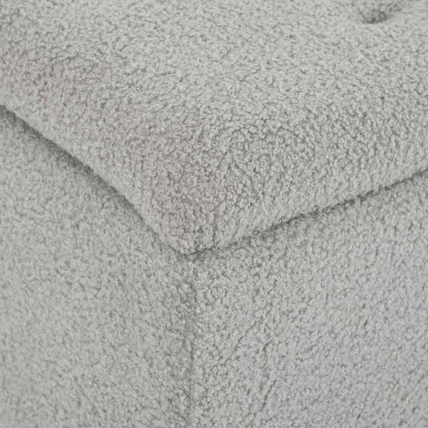 Close-up of grey boucle-style fabric upholstery on a storage ottoman
