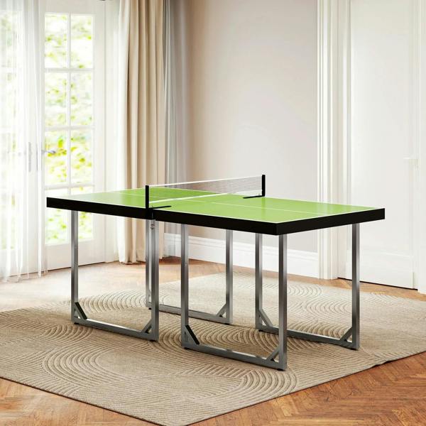 Green tabletop tennis table with black net and folding metal legs in an indoor setting.