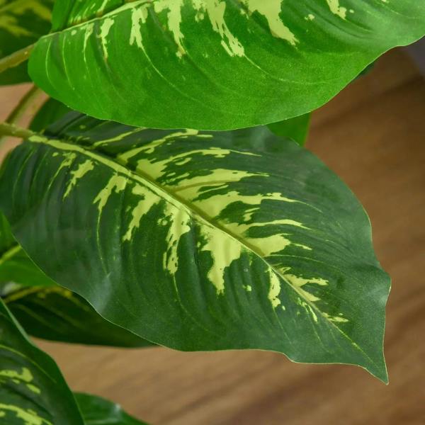 Faux rose plant with pots, close-up green leaves with pale speckles on black stems