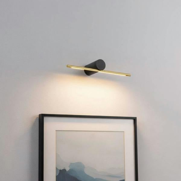 gold small picture light mounted on the wall over a picture