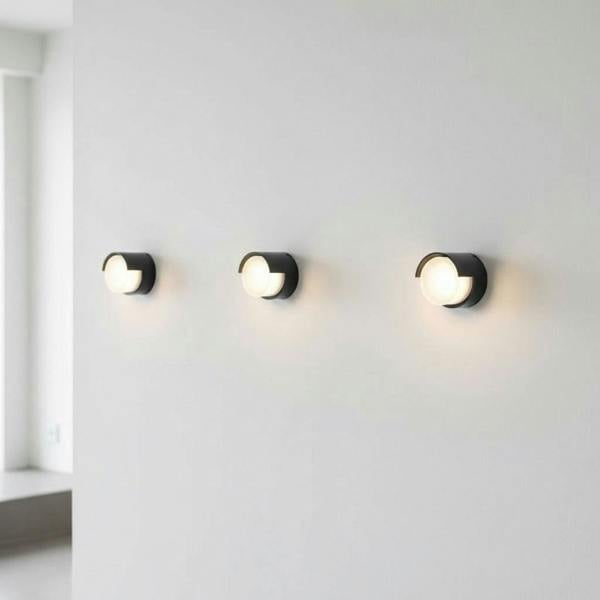 black outside wall lamp mounted on the white wall of a minimalist home