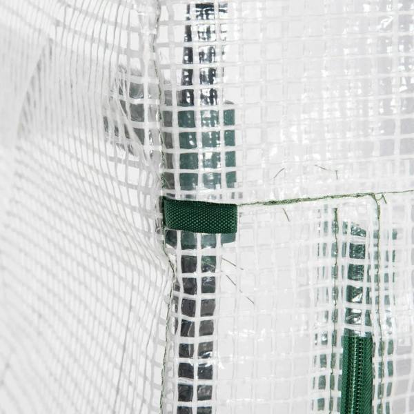 Green fabric tie straps and fasteners securing a white PE greenhouse cover
