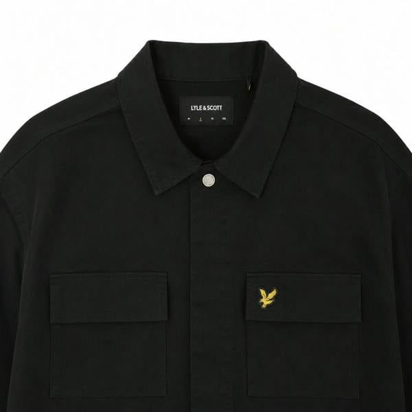 Lyle & Scott jet black washed overshirt with a classic collar, button front, and dual chest pockets with gold eagle logo.