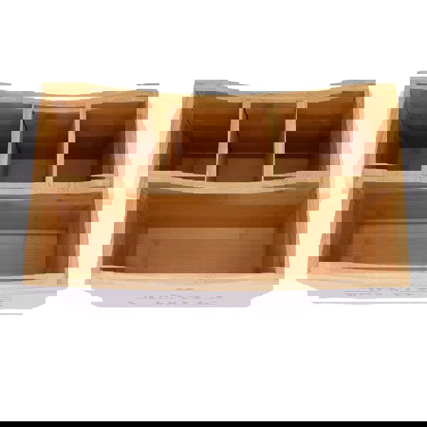 Wooden kitchen utensil holder with compartments on a white background