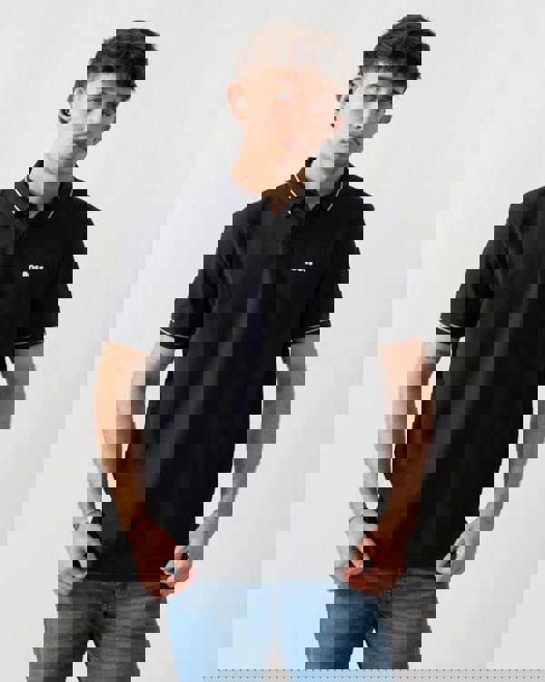 studio shot of a model wearing a BOSS Green PL_Member Mens Short Sleeve Polo Shirt in Dark Blue 402