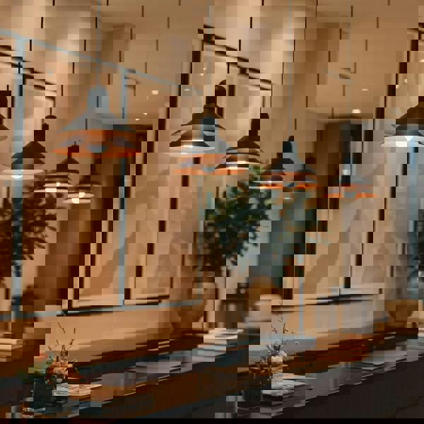 Modern black pendant light above a hotel  reception desk 