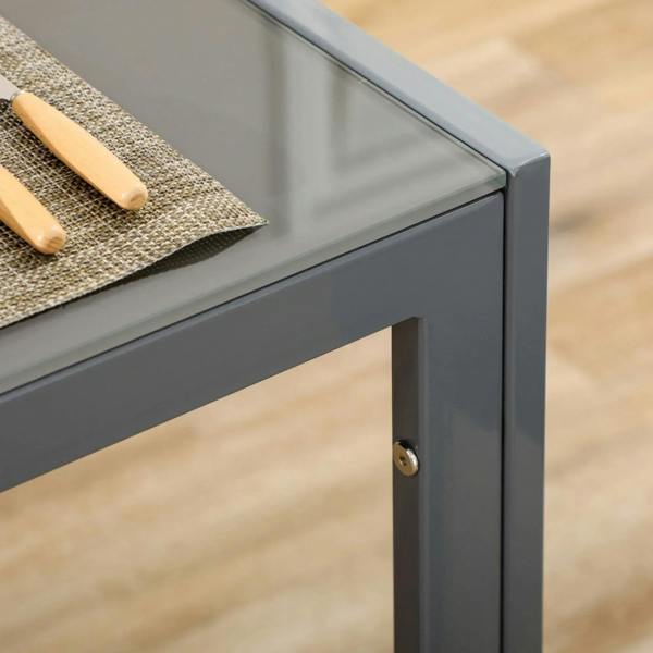 Glass tabletop corner on grey metal dining table frame with round hardware